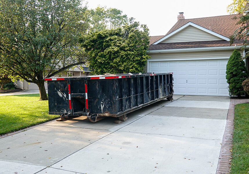 20 yd. dumpster in driveway on a sunny day 20 yd. dumpster in driveway on a sunny day